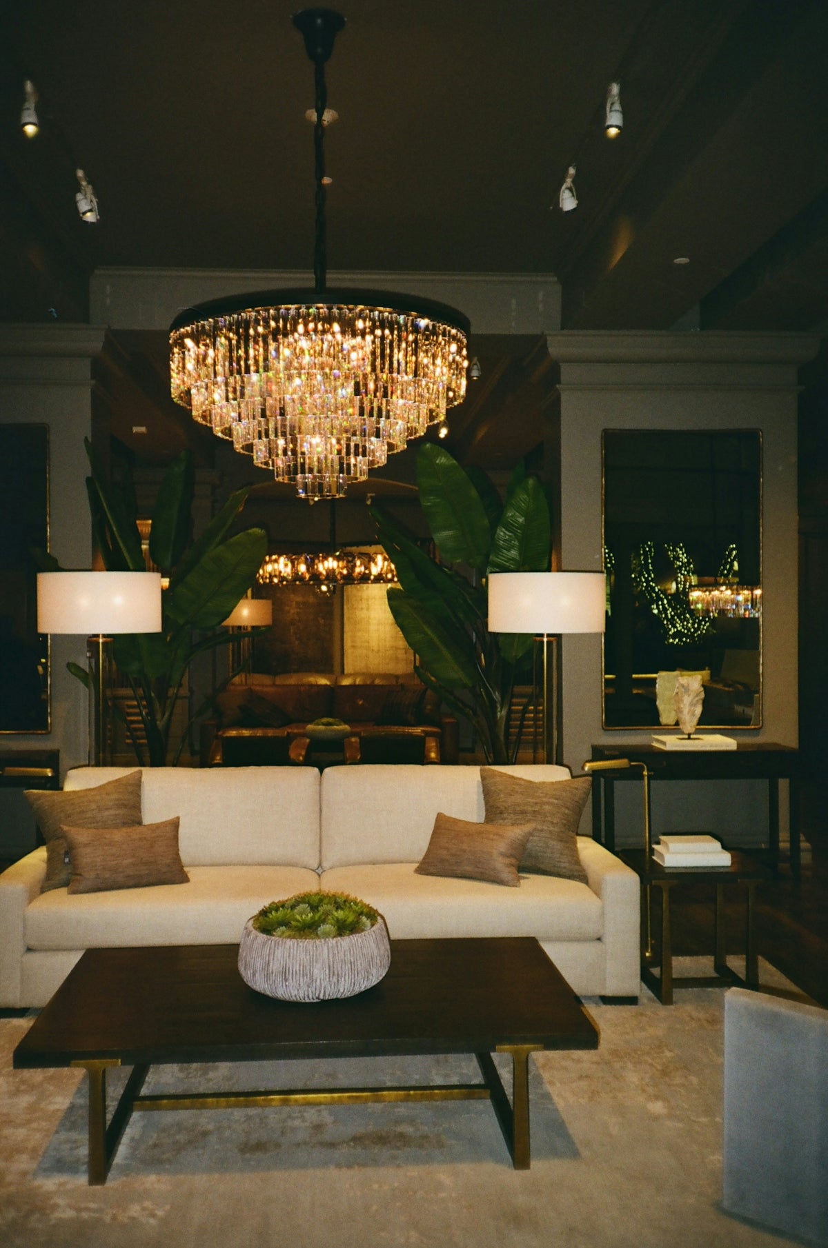 a living room filled with furniture and a chandelier