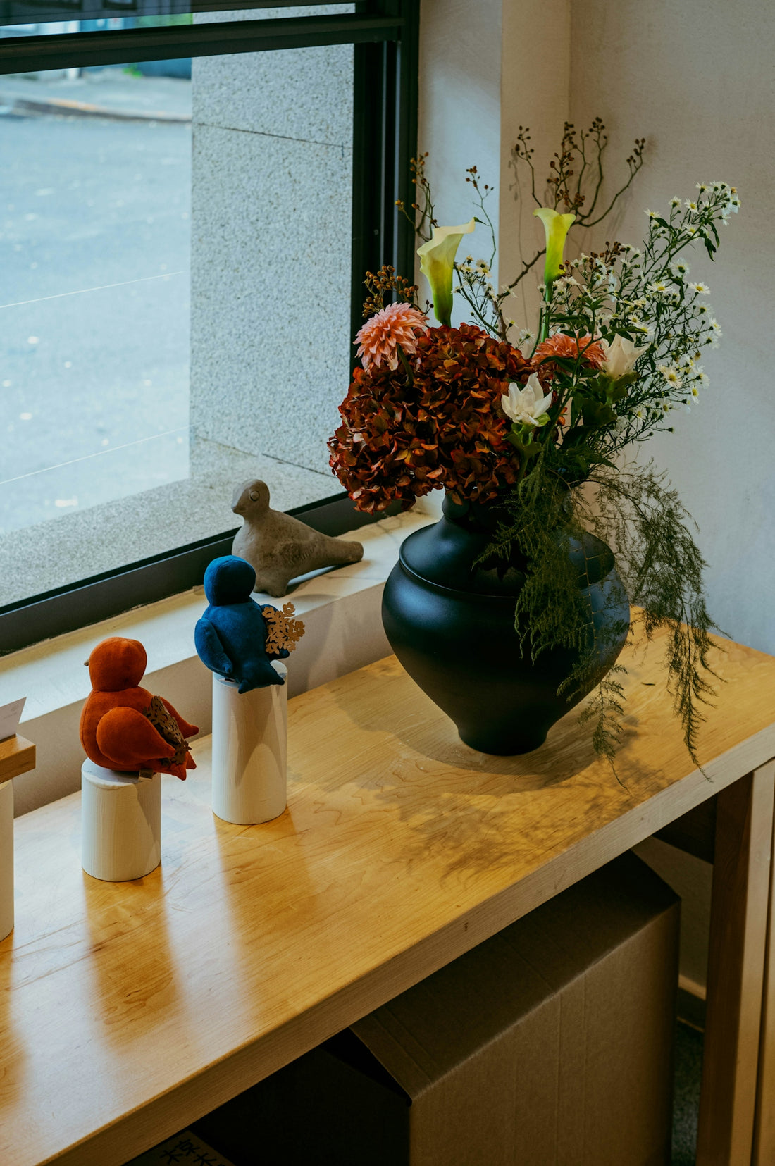 Decorative birds and flowers on a wooden shelf