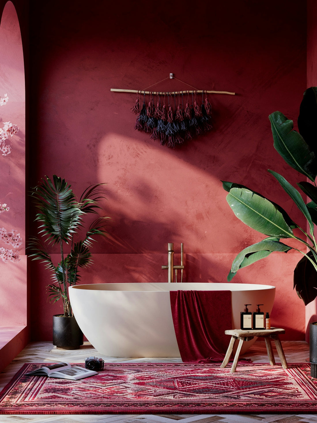 Luxurious red bathroom with freestanding tub, plants, and bohemian decor.